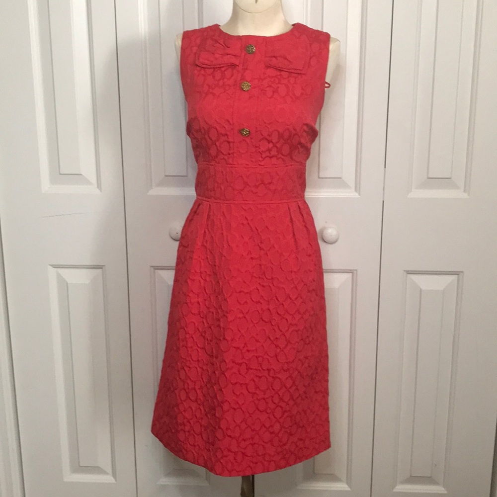 Coral dress with adorable detailing.